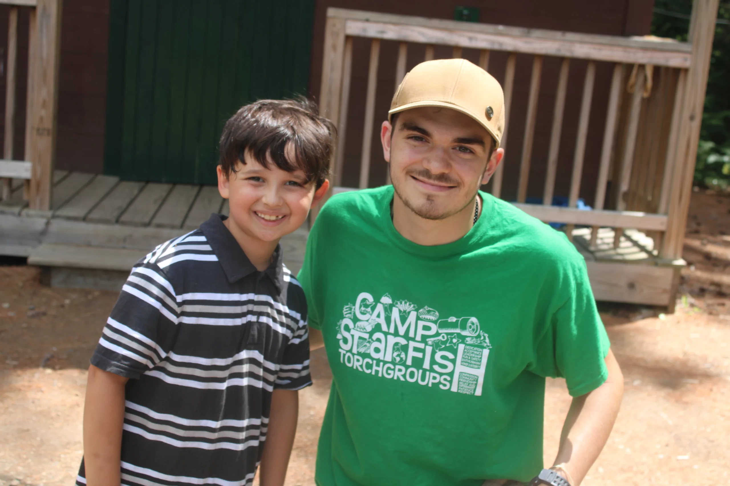 Smiling Camp Counselor and camper boy at Camp Starfish