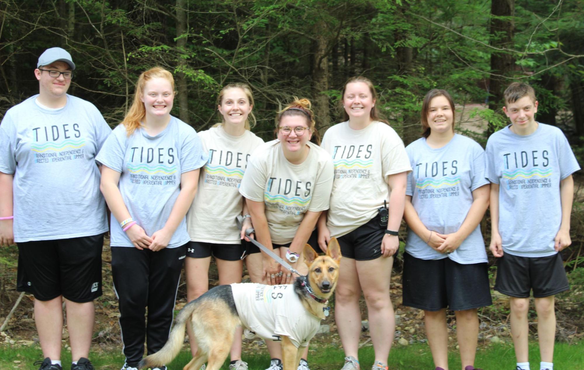 Smiling camper teens wearing TIDES shirts at Camp Starfish