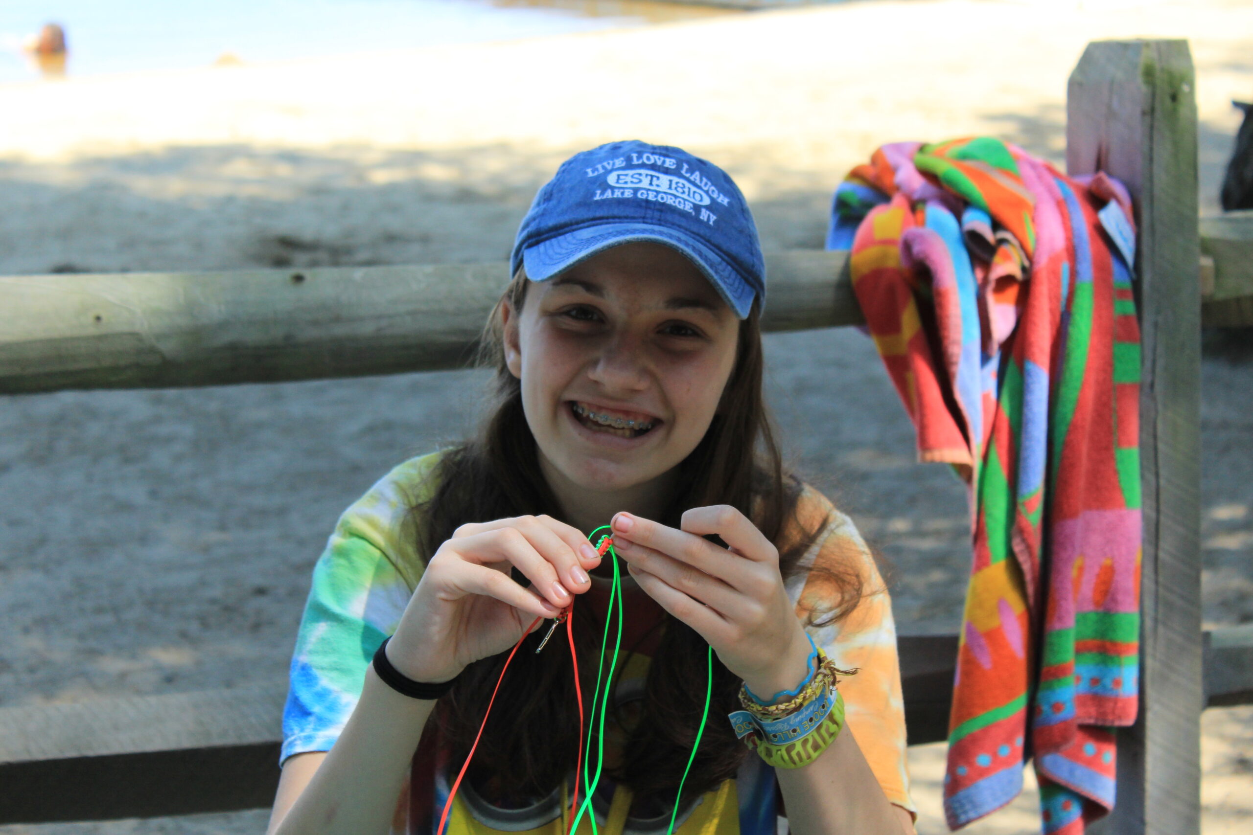 Camper girl smiling while asking bracelets at Camp Starfish