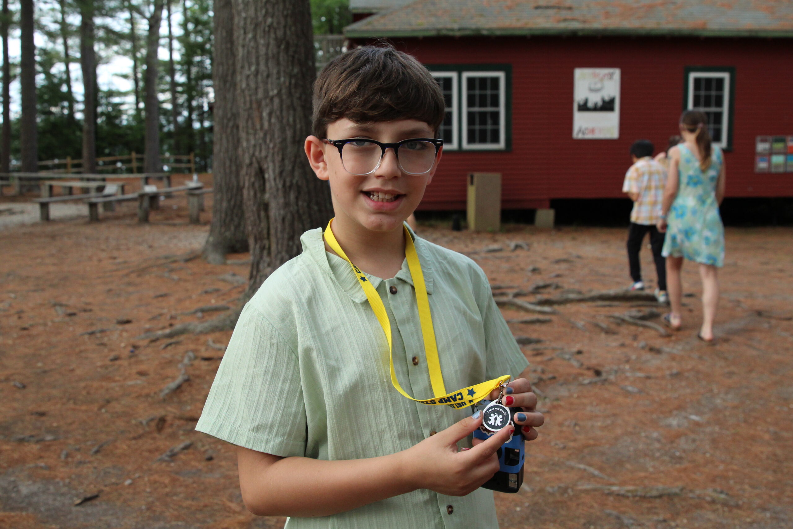 summer camp kid shows award from camp